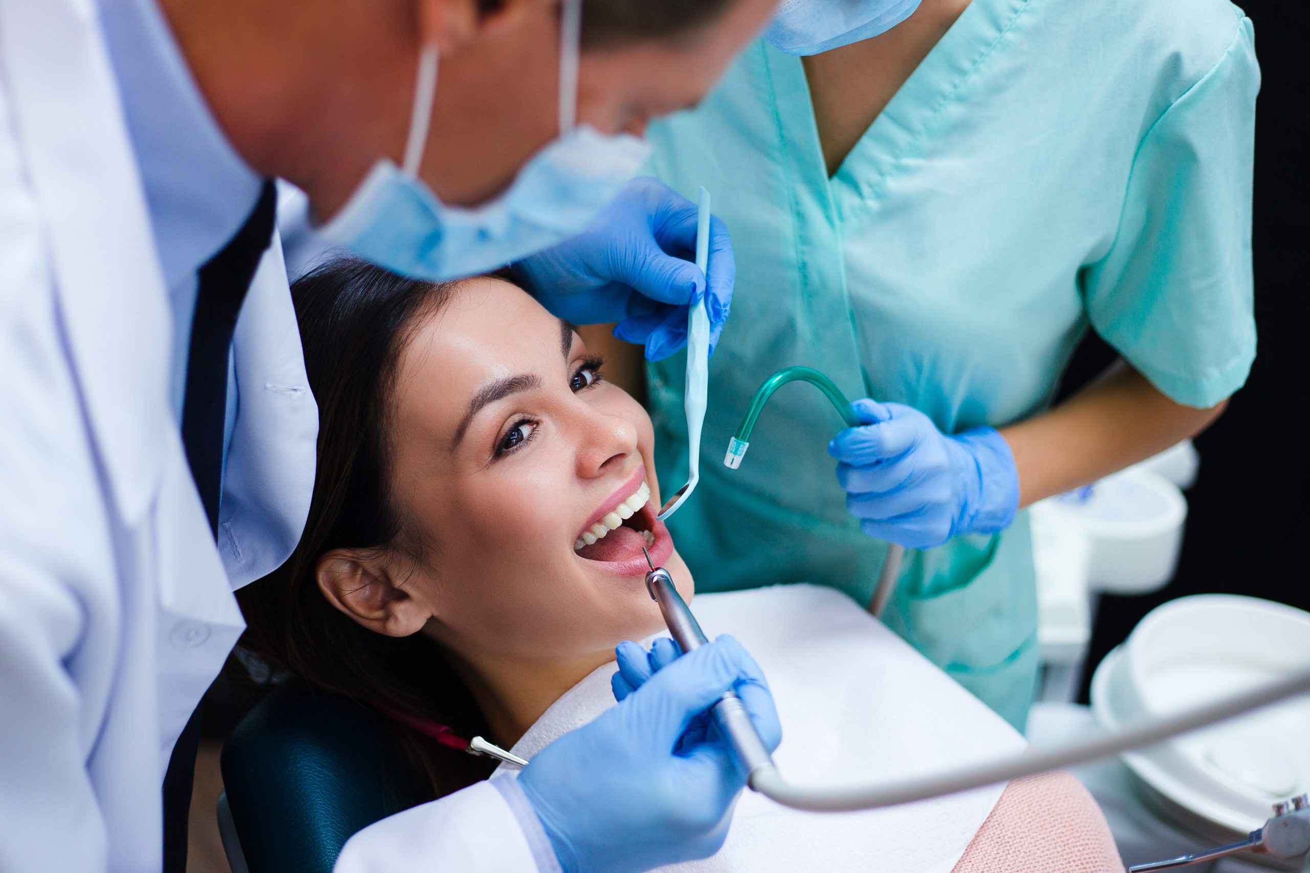 Woman smiling during a dental procedure