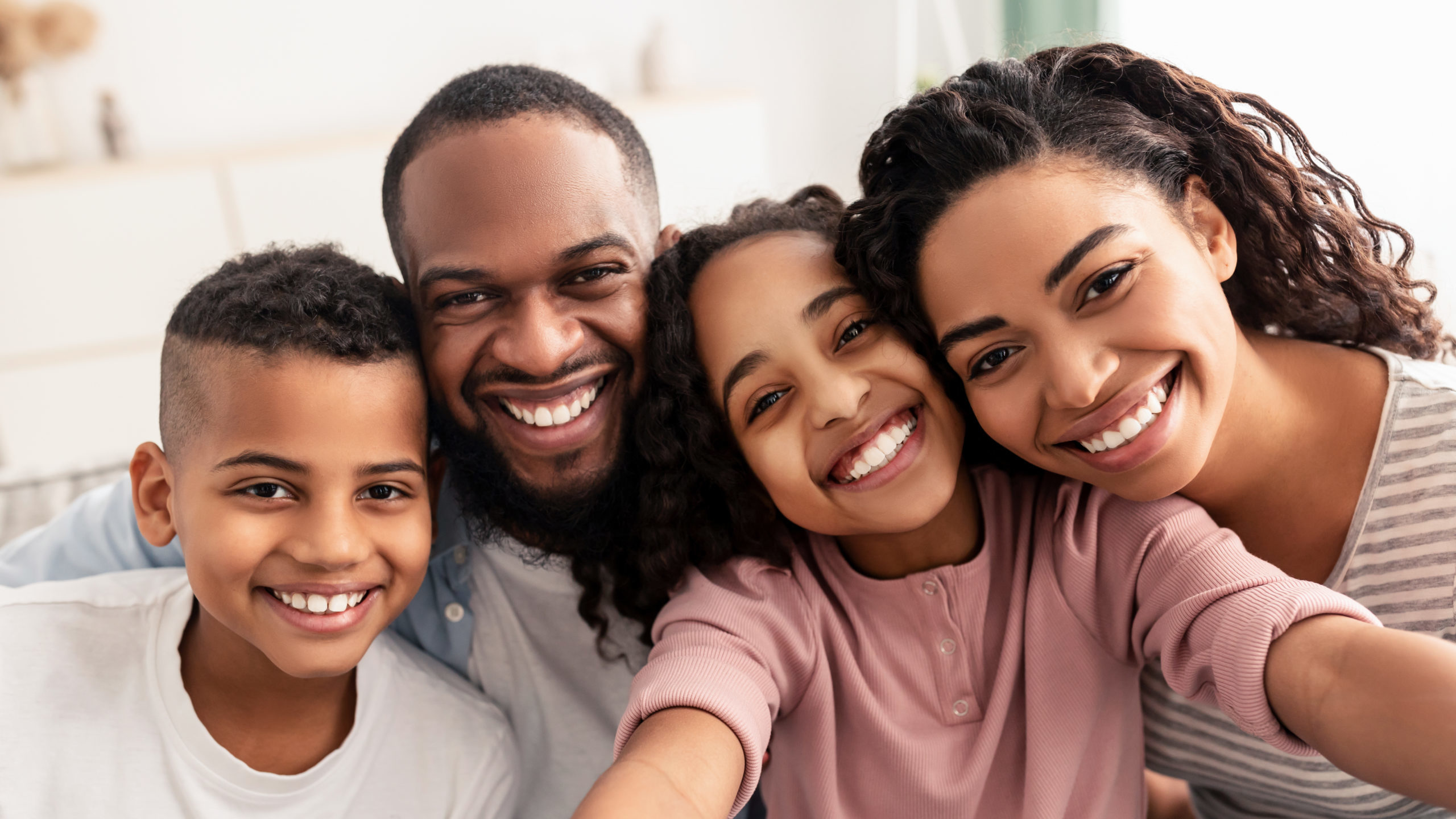 Portrait of African American family taking a selfie together at home